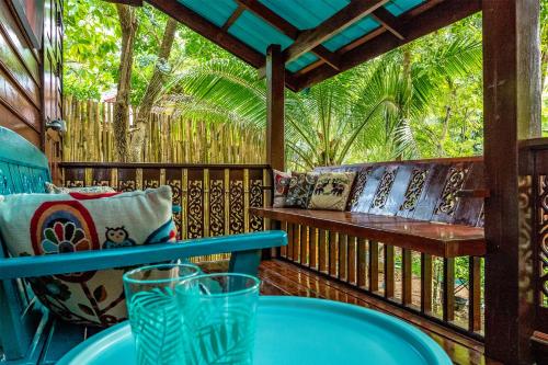 a porch with a bench and a table at Baan Kiao in Haad Yao