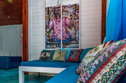 a blue couch with pillows on a porch at Baan Kiao in Haad Yao