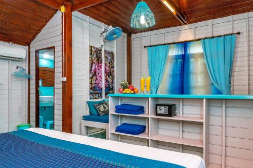 a bedroom with a bed and a window and a tub at Baan Kiao in Haad Yao