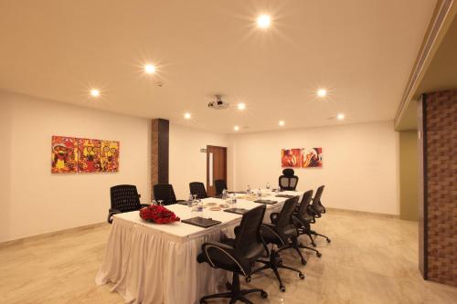 a conference room with a long table and chairs at Hotel Park Residency Thrissur in Trichūr