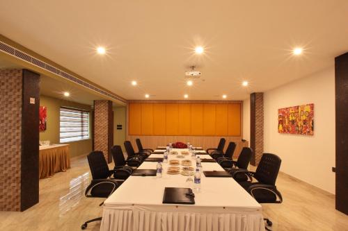 a conference room with a long table and chairs at Hotel Park Residency Thrissur in Trichūr