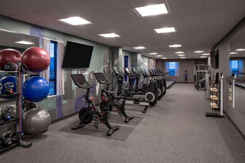 a gym with rows of exercise bikes and weights at Hyatt House Indianapolis Downtown in Indianapolis