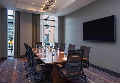 a conference room with a long table and chairs at Hyatt House Indianapolis Downtown in Indianapolis