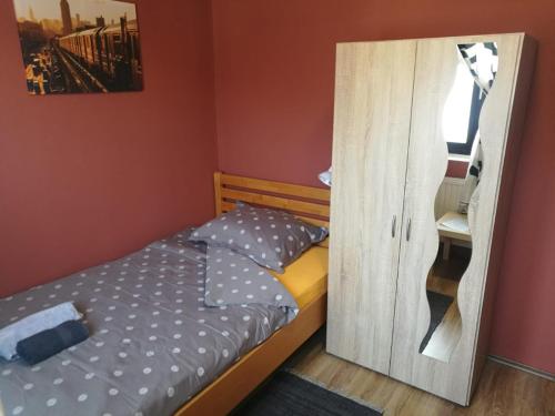 a bedroom with a bed and a wooden door at City Break Rooms Zagreb in Zagreb