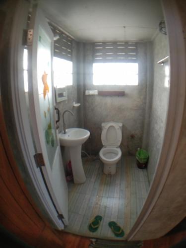 a small bathroom with a toilet and a sink at Slowlife House Ayothaya in Phra Nakhon Si Ayutthaya