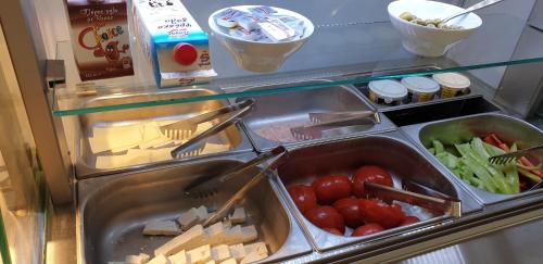 a refrigerator filled with lots of food and vegetables at Isalos Suites in Néa Péramos
