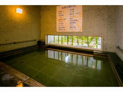 a pool of water in a room with a window at Super Hotel Natural Hot Springs Fuji Honkan in Fuji