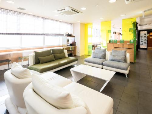ein Wohnzimmer mit 2 Sofas und einem Tisch in der Unterkunft Super Hotel Natural Hot Springs Fuji Honkan in Fuji