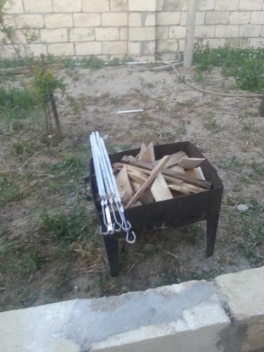 a pile of wood sitting next to a fire pit at Caspian Star in Sumqayyt