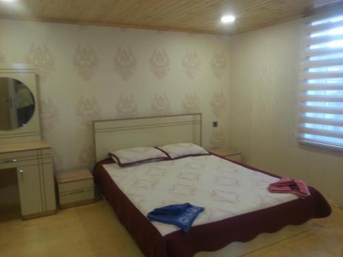 a bedroom with a bed and a television in it at Caspian Star in Sumqayyt