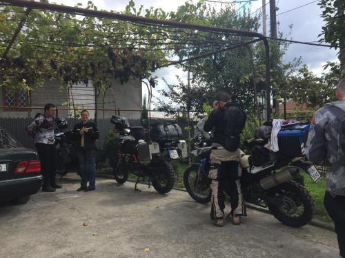 a group of men standing next to motorcycles parked at Guest House Levan II Dadiani in Zugdidi