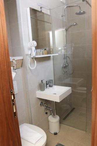 a bathroom with a shower and a sink and a toilet at Hotel Logavina 8 Garage Parking in Sarajevo