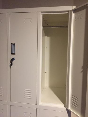 a closet with white cabinets and a door at Heart Hostel and Diner 女性専用Onlyfemale in Ise