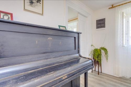 a piano in a living room with at Apartments Ivna in Veli Lošinj