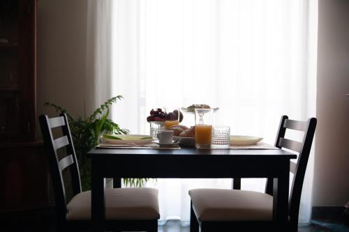 a black table with a plate of food on it at Casa del Marchese B&B in Riposto