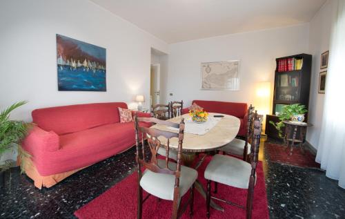 a living room with a red couch and a table at Appartamento Signorile AMBIENTI SANIFICATI in Messina