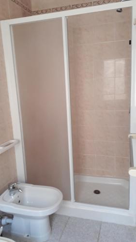 a shower in a bathroom with a toilet and a sink at Hotel La Barcarola in Marina di Campo
