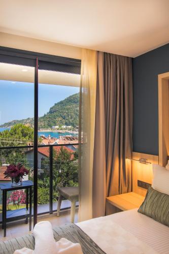 a bedroom with a large window with a view at AMOSSİA Elite Boutique Hotel in Turunc