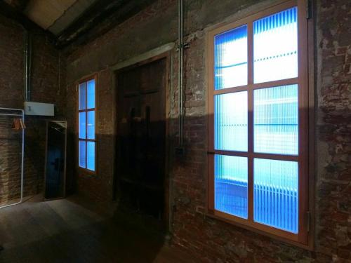 an empty room with a window in a brick wall at 想起天井老宅民宿Thinking Homestay in Tainan