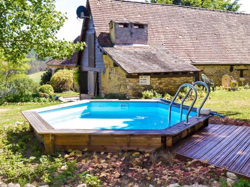 a swimming pool in front of a house at Magnificent holiday home with pool in Thenon in Thenon