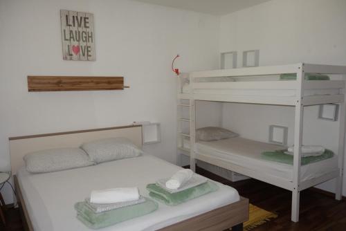 a bedroom with two bunk beds and a shelf at Apartment Beli Kriz in Piran