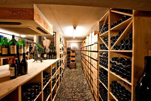a wine cellar with lots of bottles of wine at Hotel Donatz in Samedan