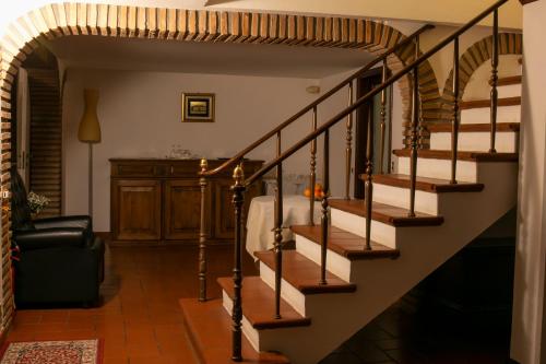 a staircase in a living room with a stair case at Ai Giardini di San Vitale in Ravenna