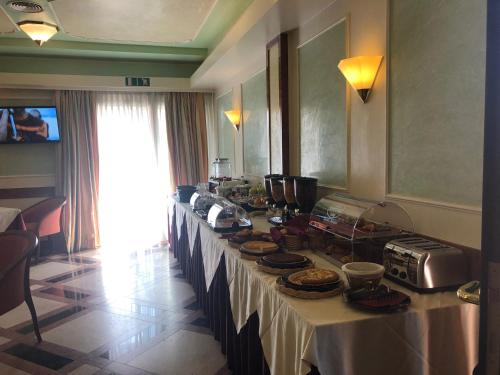 a long table with food on it in a room at Hotel Motel Regal in Vermezzo