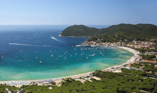 an aerial view of a beach with boats in the water at Hotel La Barcarola in Marina di Campo