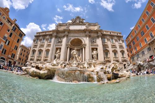 a large building with a fountain in front of it at Rome Luxury House - The House in Rome