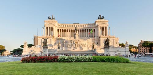 a large building with a grassy field in front of it at Rome Luxury House - The House in Rome