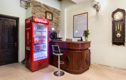 uma máquina de cocacola ao lado de um bar com um refrigerador de bebidas em Nhà Nghỉ Trà My em Như Thức