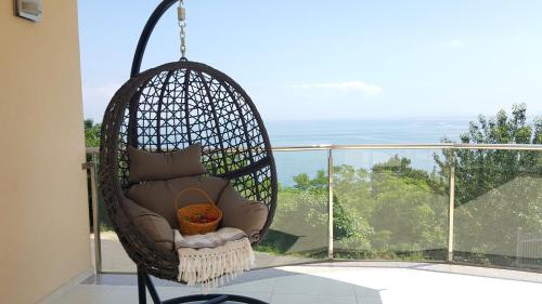 a swing chair hanging on a balcony with a view at Camelia in Opatija