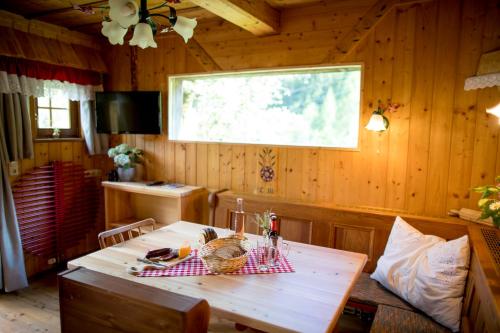 a wooden dining room with a table and a window at Chalet "Knusperhäuschen" in Murau