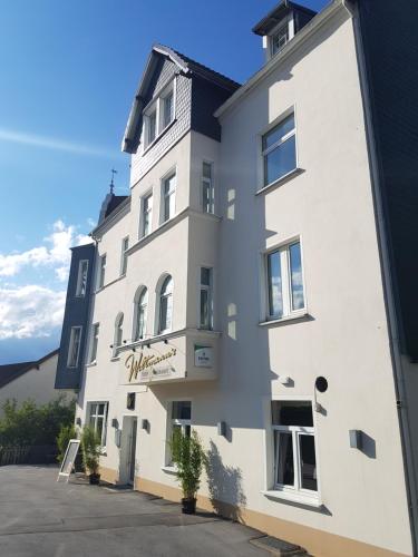 a white building with a sign on it at Weltmann`s Hotel & Restaurant in Ennepetal