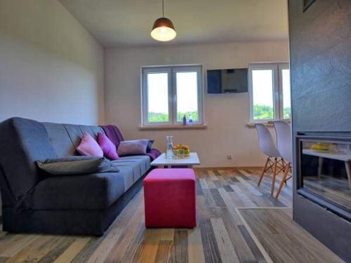 a living room with a couch and a table at RESET INN in Zawóz