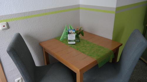 a small table with a bottle of milk and flowers on it at Landpension Wendfeld in Sanitz