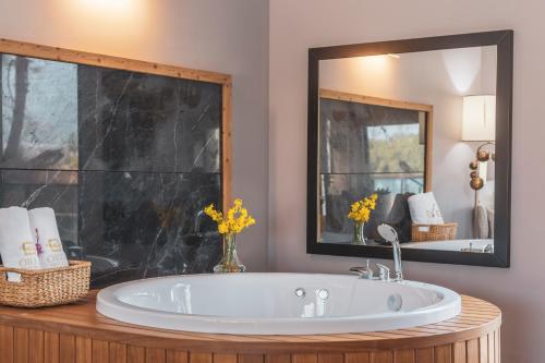 a bathroom with a tub and a large mirror at Orka Cove Hotel Penthouse & Suites Adults Only in Fethiye
