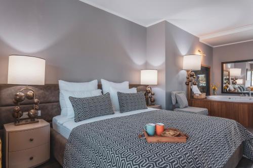 a bedroom with a large bed with a wooden tray on it at Orka Cove Hotel Penthouse & Suites Adults Only in Fethiye