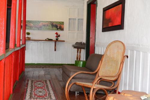a living room with a couch and a chair at Ecohotel Pinohermoso Reserva Natural in Salento