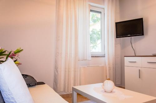 a living room with a table and a window at Kaja Apartments in Fažana