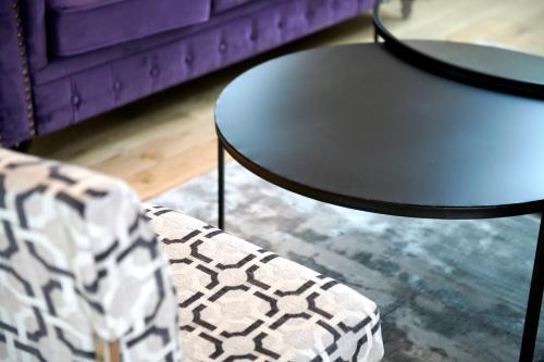 a living room with a table and a couch at L'appartement et les Suites de VJL... in Avize