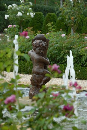 a statue of a little girl in a garden at Borgo Santo Pietro in Chiusdino