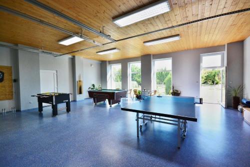 an empty room with ping pong tables and pool tables at U Fousáče in Hrabětice