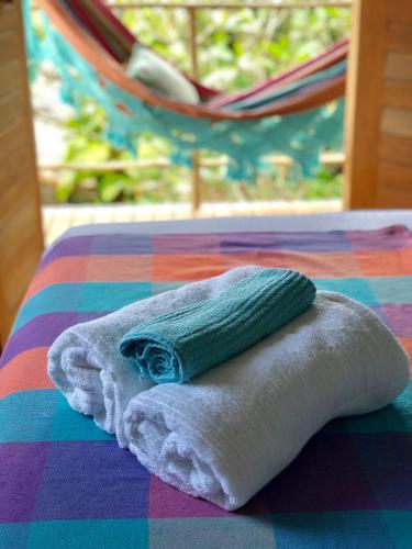 a towel sitting on top of a table with a hammock at Cumelen in Jericoacoara