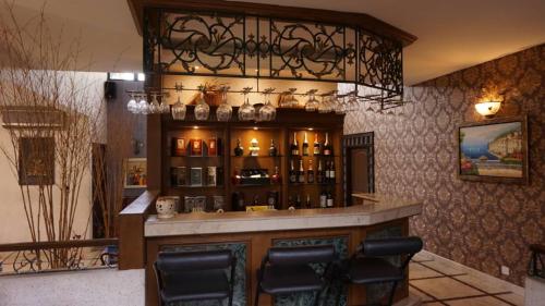 a bar in a restaurant with a chandelier at Kinta Bali Villa in Ipoh