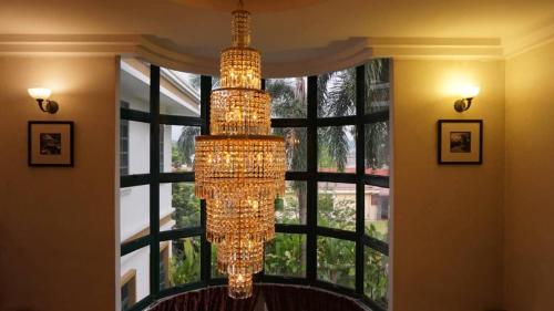 a large chandelier hanging in front of a window at Kinta Bali Villa in Ipoh