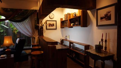 a living room with a desk and a window at Kinta Bali Villa in Ipoh