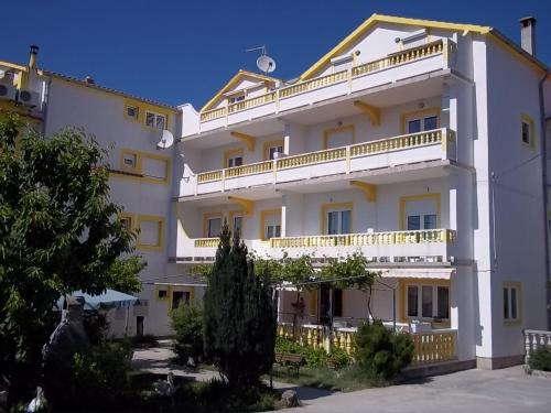a large white building with balconies on it at Apartments Mare in Banjol