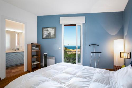 a bedroom with a large white bed and a window at La Caleta in Begur